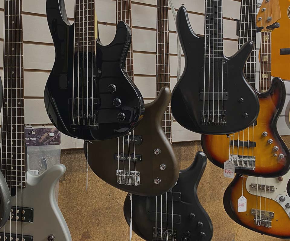 image of bass guitars hanging up at WestSide Music